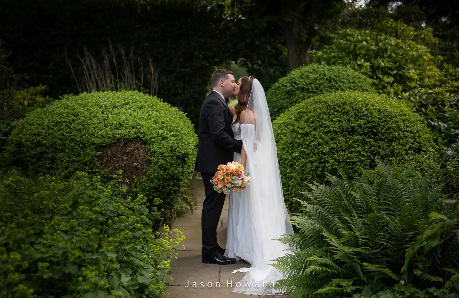 Newlyweds in the gardens at Rowton Hall Hotel, Chester
