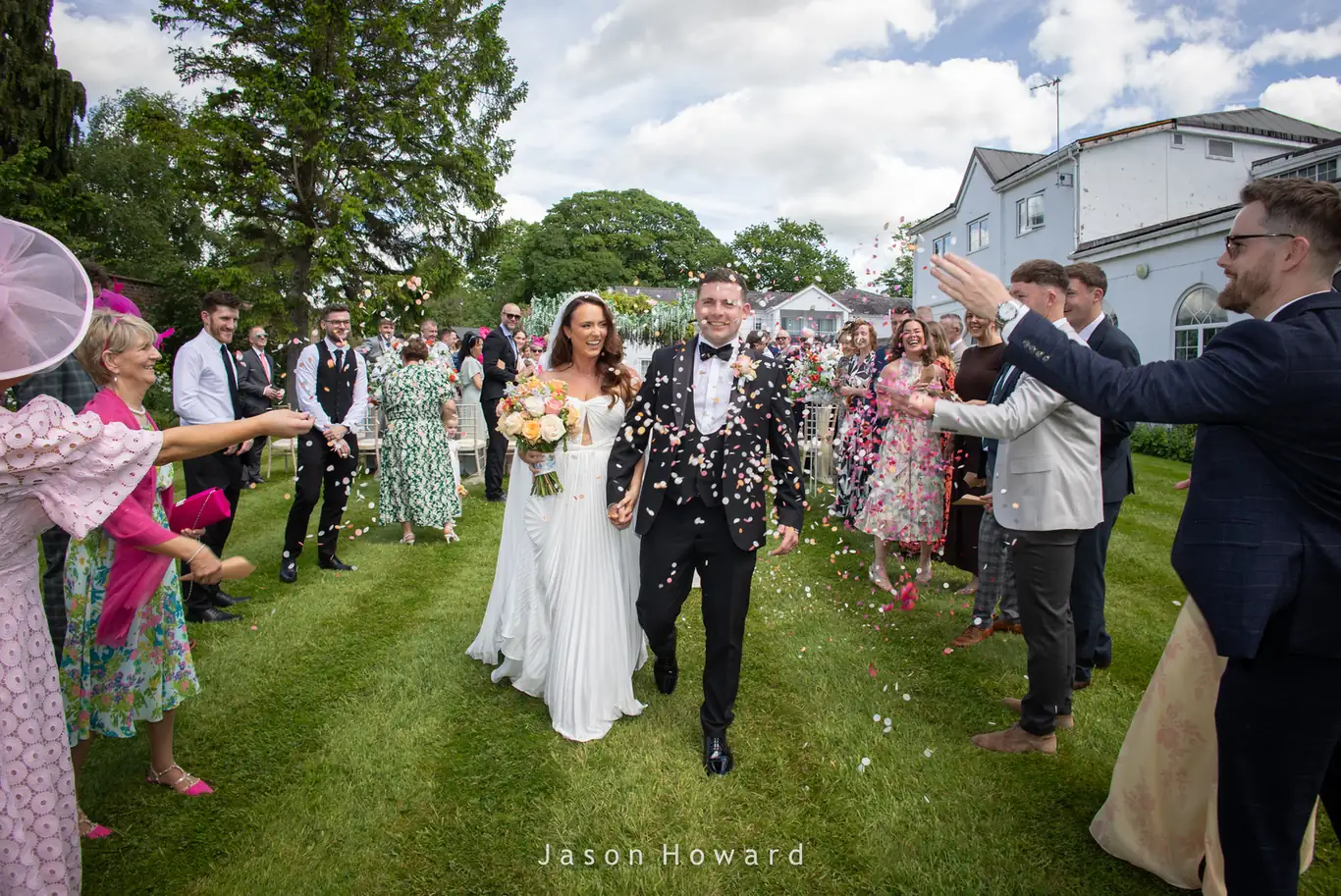 Confetti throw photograph at a Rowton Hall Hotel wedding, Cheshire