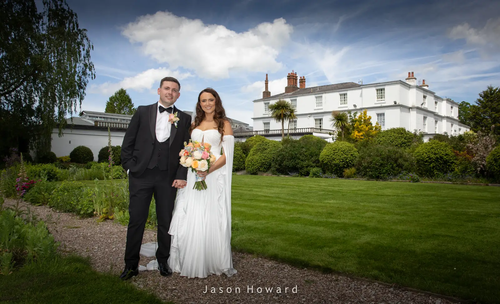 Newlyweds in the gardens of Rowton Hall Hotel, Chester