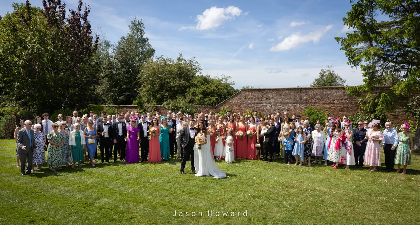 Wedding group photograph on the lawns at Rowton Hall Hotel, Cheshire
